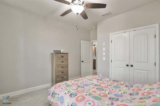 carpeted bedroom with ceiling fan and a closet