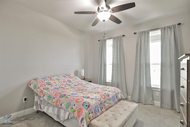 bedroom with ceiling fan and light carpet