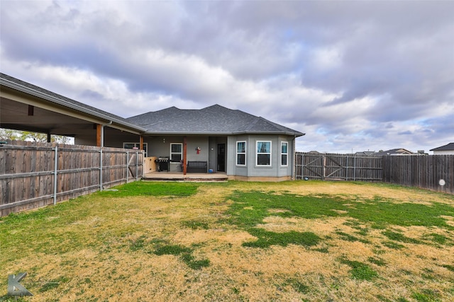 rear view of house featuring a yard and a patio area