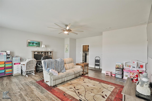 living room with wood-type flooring and ceiling fan