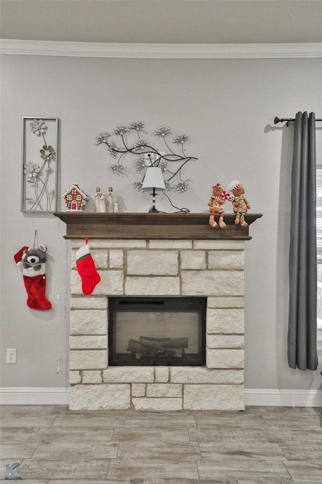 room details featuring a stone fireplace and crown molding