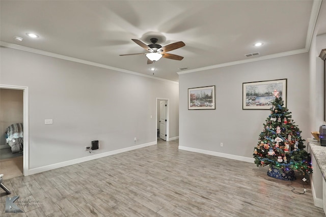 interior space featuring crown molding, light hardwood / wood-style flooring, and ceiling fan