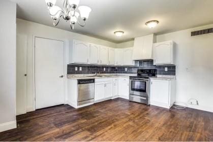 kitchen featuring dark hardwood / wood-style floors, white cabinetry, stainless steel appliances, and premium range hood