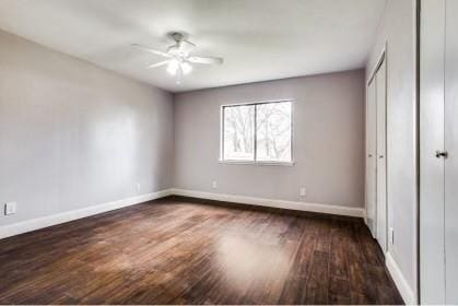 unfurnished bedroom featuring ceiling fan and dark wood-type flooring