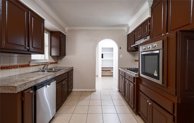 kitchen with dark brown cabinets, light tile patterned floors, sink, and appliances with stainless steel finishes