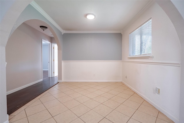 spare room with light tile patterned floors and ornamental molding