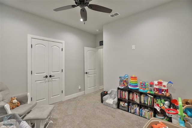 playroom featuring ceiling fan and light colored carpet