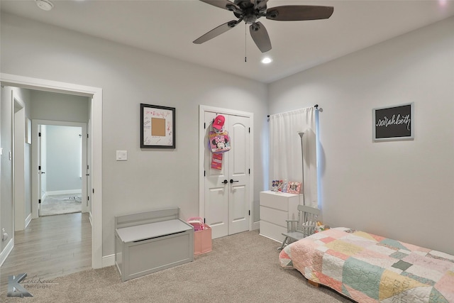 bedroom with light carpet and ceiling fan