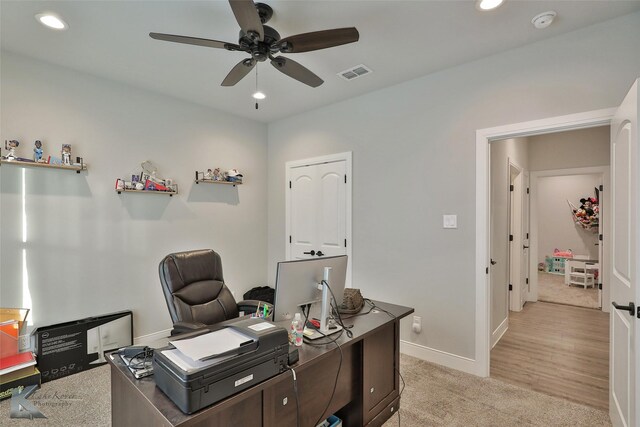 home office featuring light colored carpet and ceiling fan