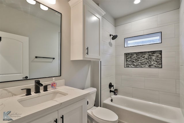 full bathroom featuring vanity, toilet, and tiled shower / bath