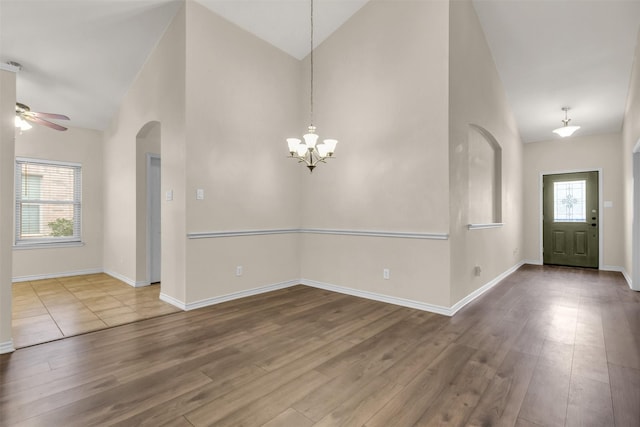 entryway with a wealth of natural light, vaulted ceiling, and wood-type flooring