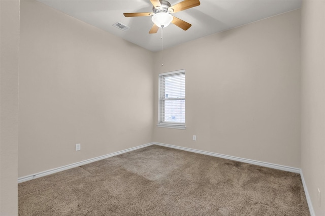 carpeted spare room featuring ceiling fan