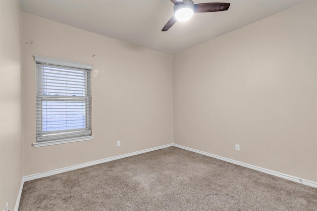 empty room featuring ceiling fan and light carpet