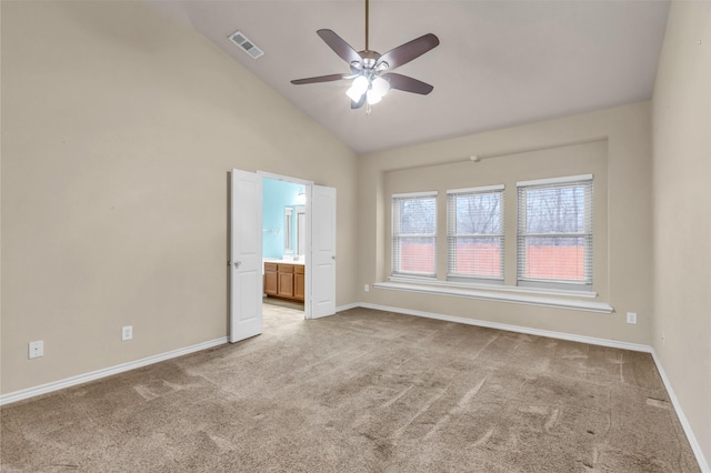 carpeted spare room with high vaulted ceiling and ceiling fan