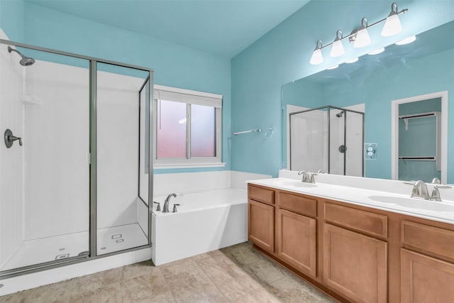 bathroom featuring tile patterned flooring, vanity, and separate shower and tub