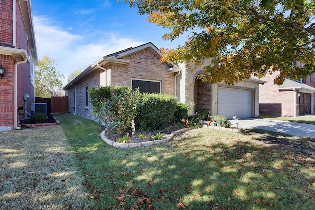 view of front of property with a front yard, central AC, and a garage