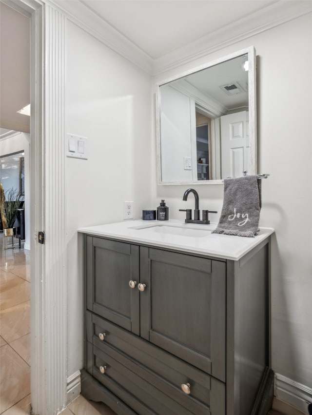 bathroom with crown molding, tile patterned floors, and vanity