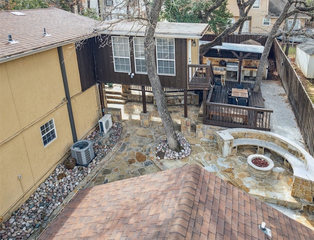 view of patio featuring a fire pit and ac unit