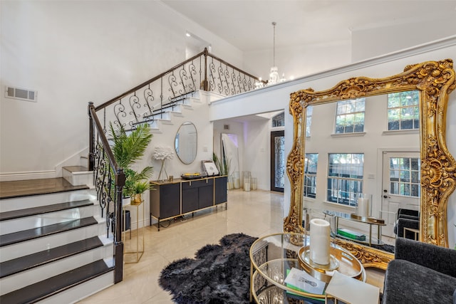 interior space with a towering ceiling and a notable chandelier