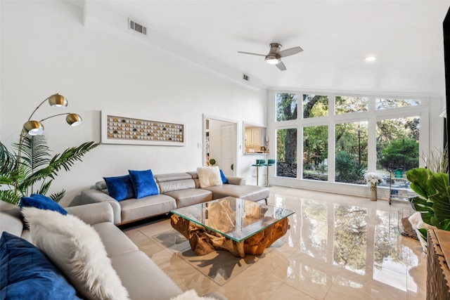 tiled living room with ceiling fan and vaulted ceiling