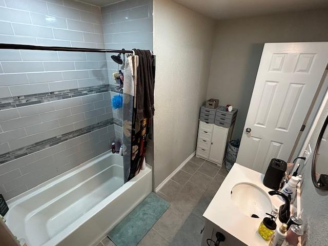 bathroom with tile patterned flooring, vanity, and shower / bath combo with shower curtain