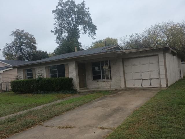 single story home with a garage and a front yard