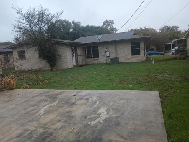 rear view of house with a yard