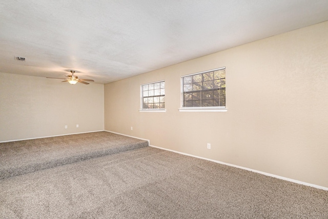 empty room featuring carpet and ceiling fan