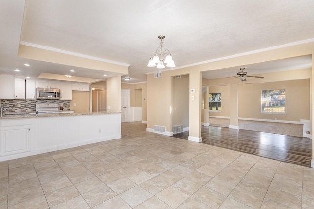 interior space with light stone countertops, range, pendant lighting, white cabinets, and light wood-type flooring