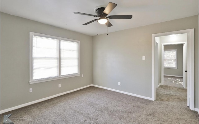 empty room featuring light carpet and ceiling fan