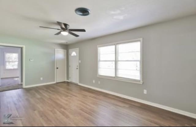 empty room featuring hardwood / wood-style floors and ceiling fan