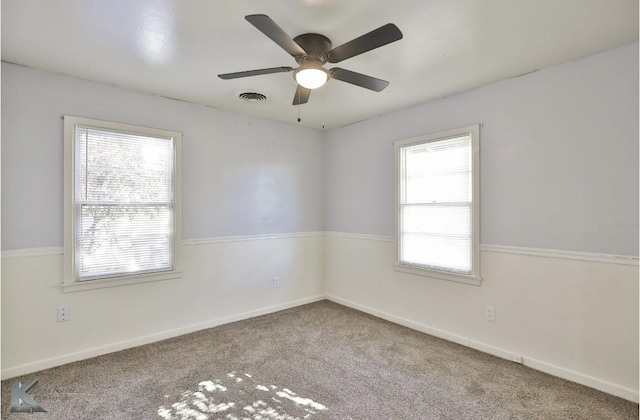 unfurnished room with ceiling fan and carpet flooring