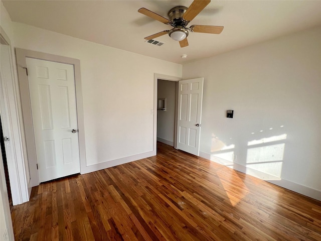 unfurnished bedroom with dark hardwood / wood-style floors and ceiling fan