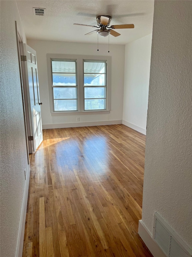 unfurnished room with light hardwood / wood-style floors and ceiling fan