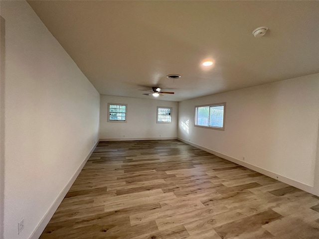 unfurnished room with ceiling fan and light wood-type flooring