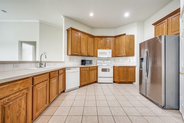 kitchen with sink, ornamental molding, appliances with stainless steel finishes, tasteful backsplash, and light tile patterned flooring