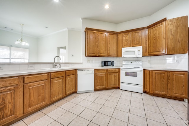 kitchen featuring sink, hanging light fixtures, a notable chandelier, crown molding, and white appliances