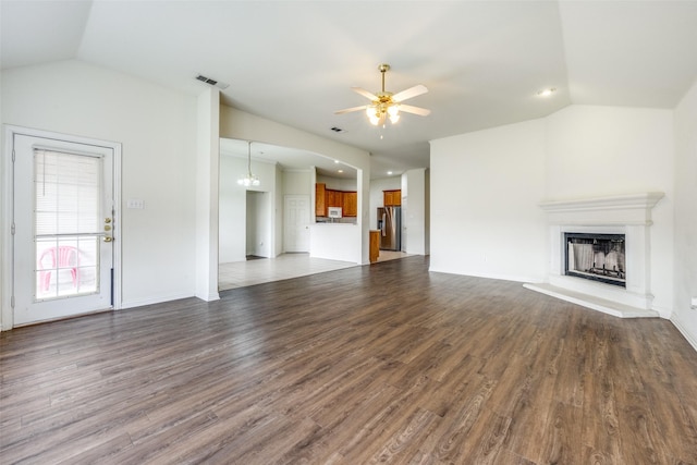 unfurnished living room with hardwood / wood-style flooring, ceiling fan, and lofted ceiling