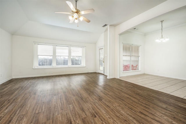 unfurnished living room with vaulted ceiling, wood-type flooring, and ceiling fan with notable chandelier