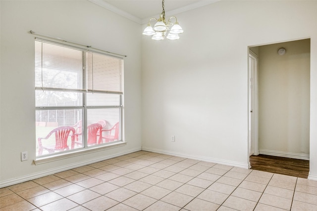 unfurnished room with light tile patterned flooring, ornamental molding, and an inviting chandelier