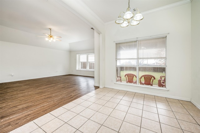 spare room with ceiling fan with notable chandelier, light hardwood / wood-style floors, and crown molding