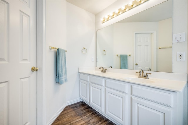 bathroom with hardwood / wood-style floors and vanity