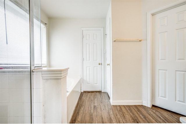 hallway with hardwood / wood-style floors