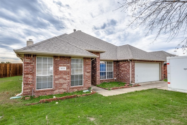 view of front of home featuring a garage and a front lawn