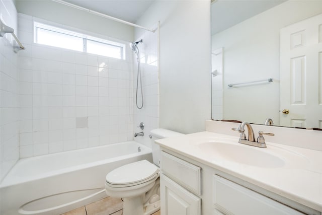 full bathroom with tile patterned floors, vanity, tiled shower / bath combo, and toilet