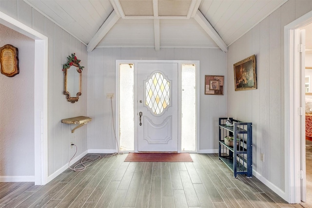 foyer with vaulted ceiling with beams and hardwood / wood-style flooring