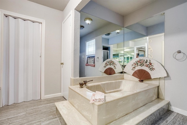 bathroom featuring hardwood / wood-style floors and a bathing tub