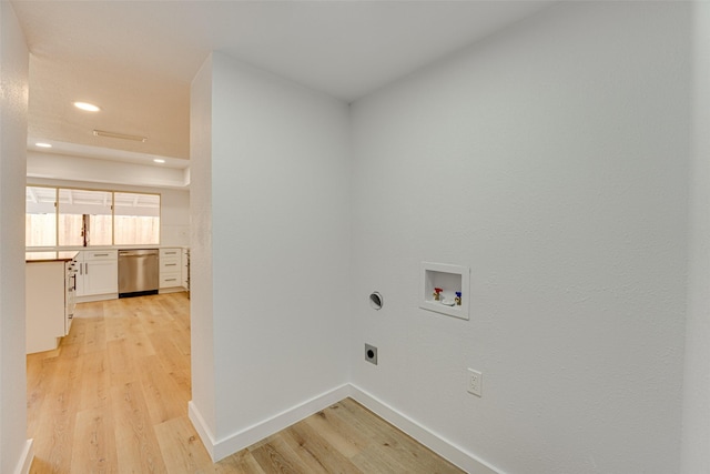 laundry room featuring washer hookup, light wood-type flooring, and electric dryer hookup