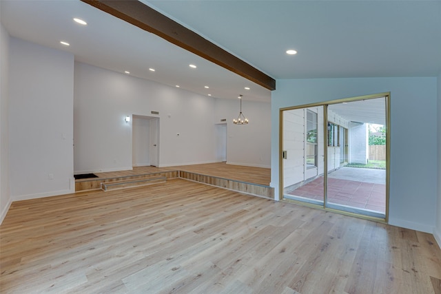 spare room with lofted ceiling with beams, light hardwood / wood-style floors, and a notable chandelier