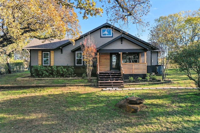 view of front of home featuring cooling unit and a front yard